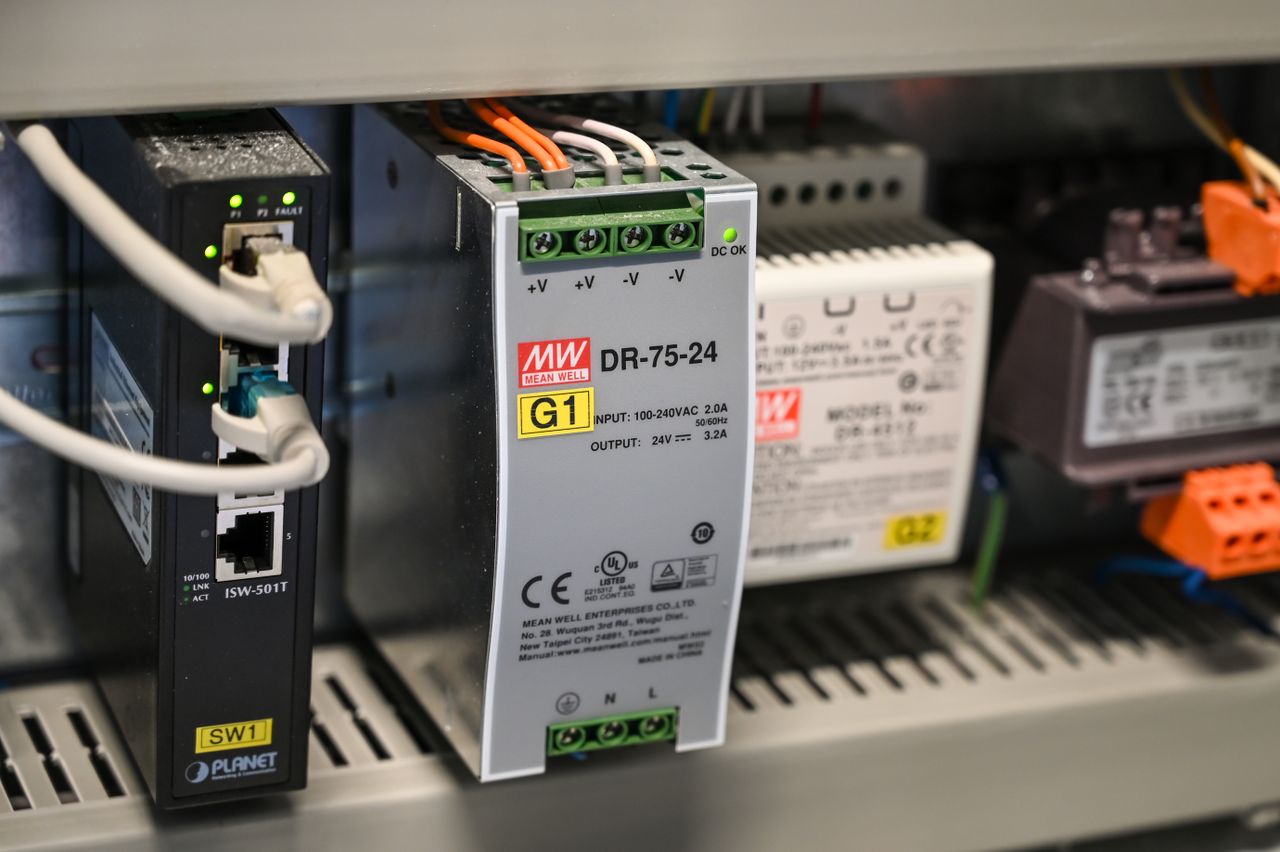Close-up of electronic components and wires inside industrial equipment.